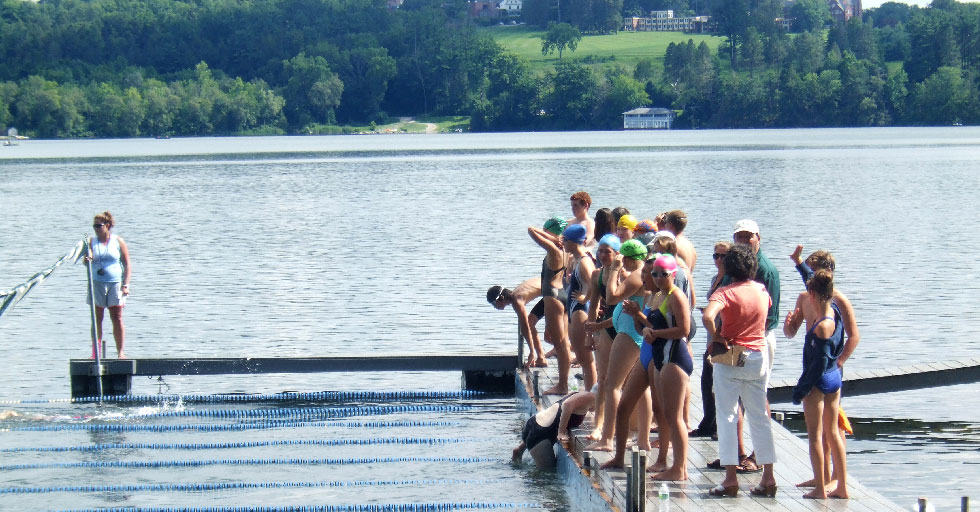 Swimmers ready to jump of the dock of the grove